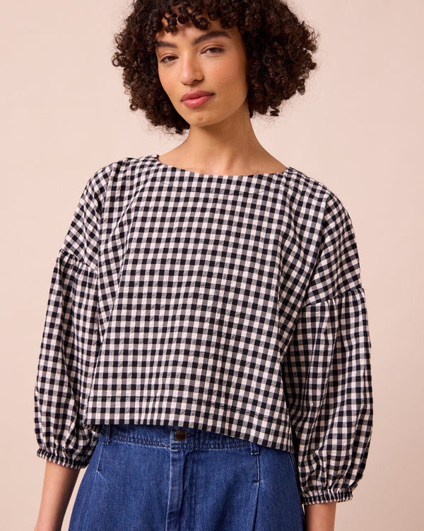 model wears aisha black and white gingham seersucker top