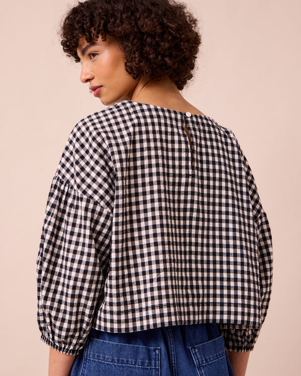 model wears aisha black and white gingham seersucker top