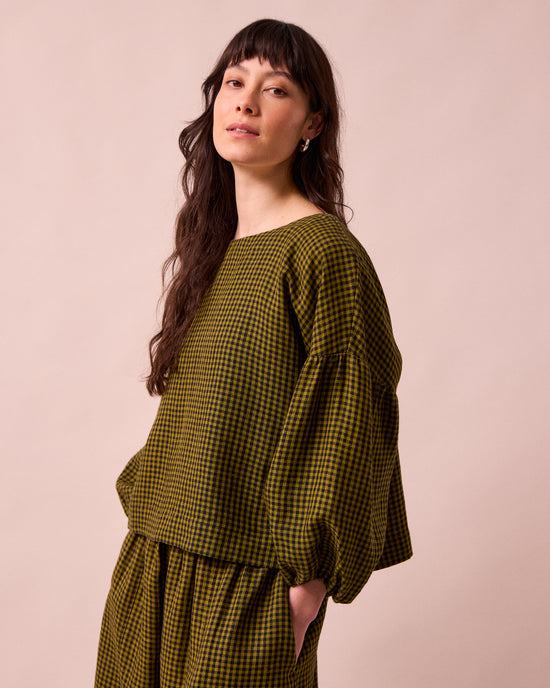 model wears the aisha fresh olive mini gingham linen top