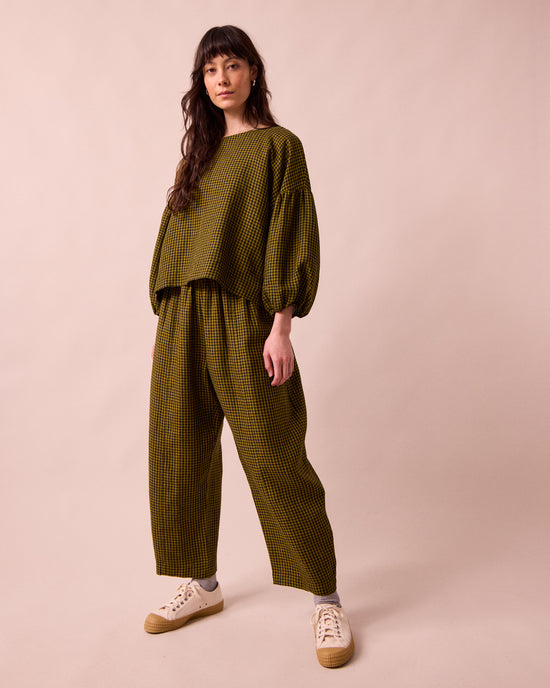 model wears the aisha fresh olive mini gingham linen top