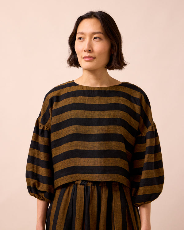 model wears aisha rust stripe linen top