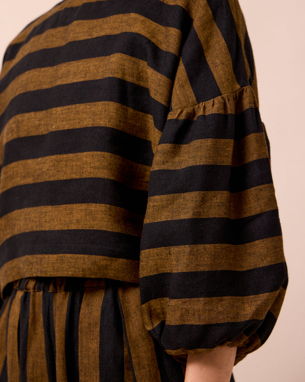 model wears aisha rust stripe linen top