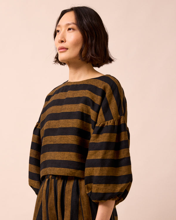 model wears aisha rust stripe linen top