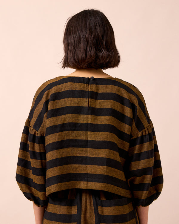 model wears aisha rust stripe linen top