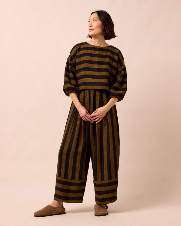 model wears aisha rust stripe linen top