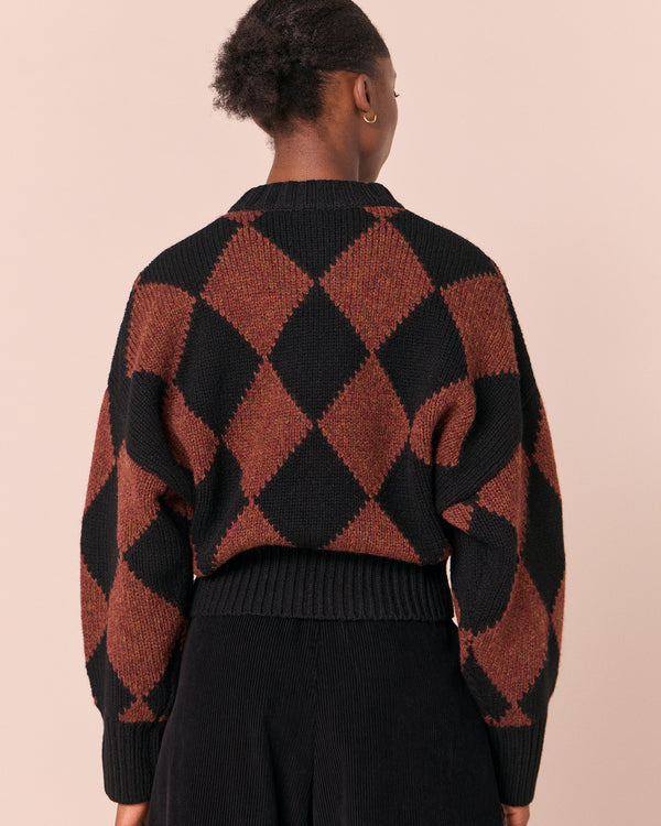 model wears alora rust harlequin knitted jumper