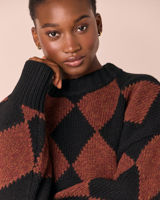 model wears alora rust harlequin knitted jumper