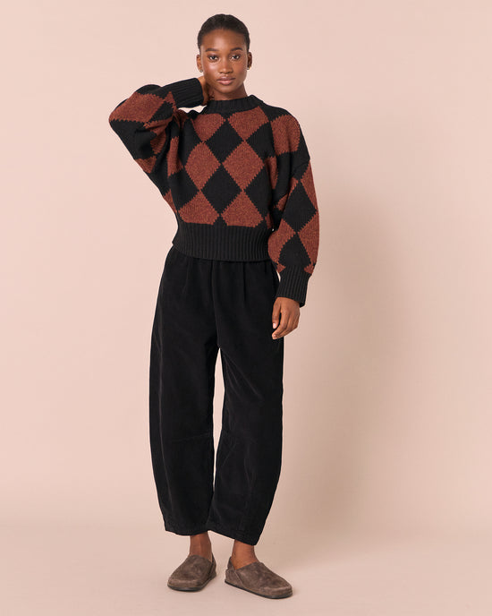 model wears alora rust harlequin knitted jumper