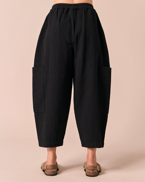 model wears amala black gauze trousers back