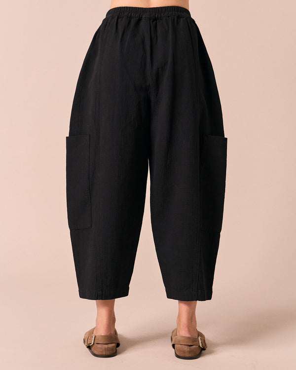 model wears amala black gauze trousers back