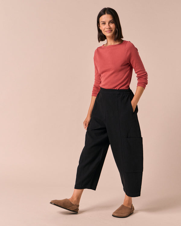 model wears amala black gauze trousers right