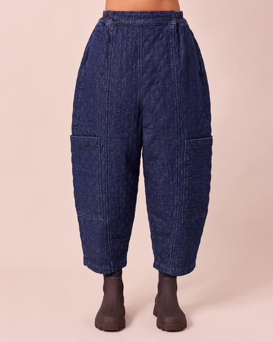 model wears amala dark blue quilted denim trousers front