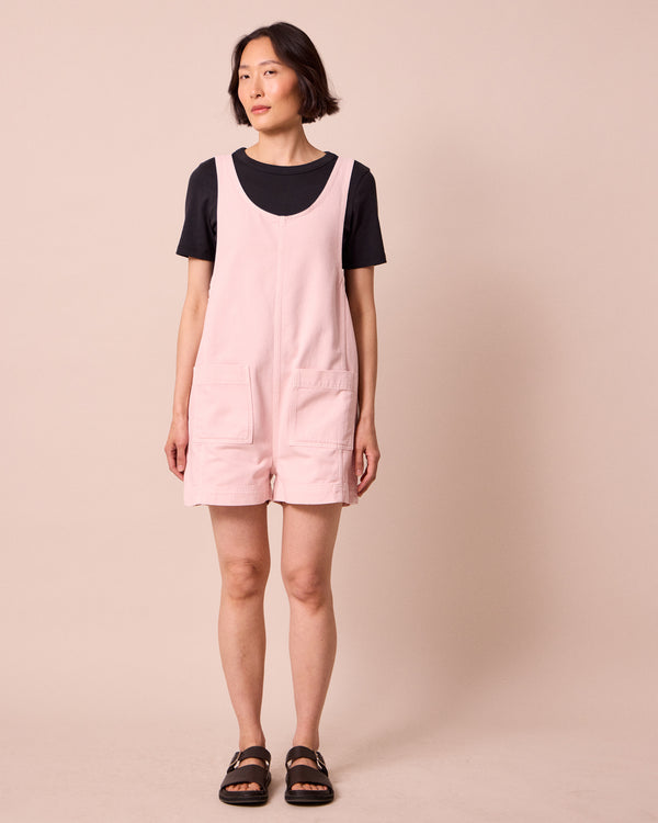 model wears anica petal pink denim playsuit