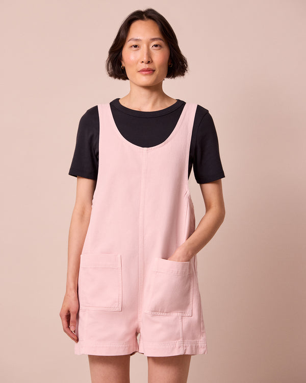 model wears anica petal pink denim playsuit