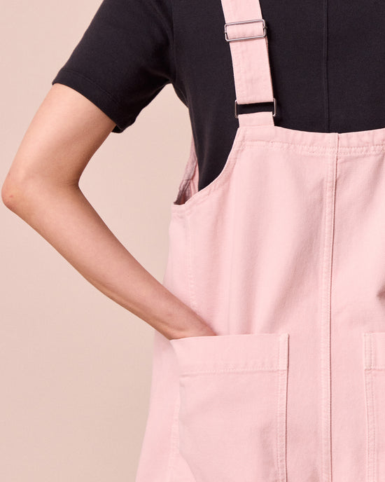 model wears anica petal pink denim playsuit