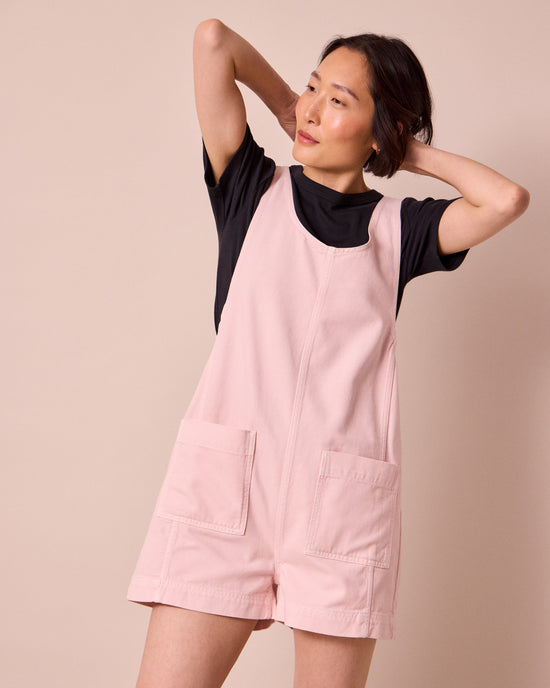 model wears anica petal pink denim playsuit
