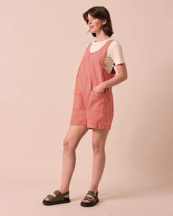 model wears anica poppy red gingham playsuit
