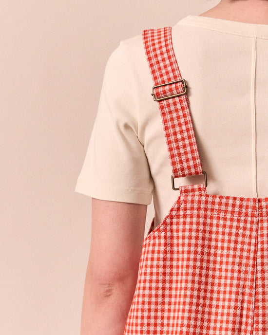 model wears anica poppy red gingham playsuit