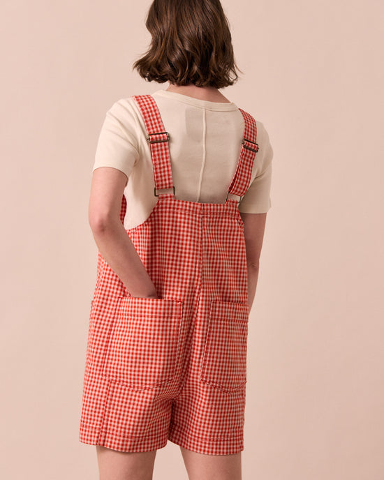 model wears anica poppy red gingham playsuit