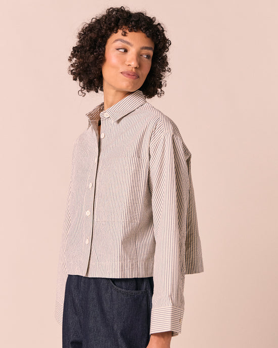 model wears anya blue and bone stripe seersucker shirt