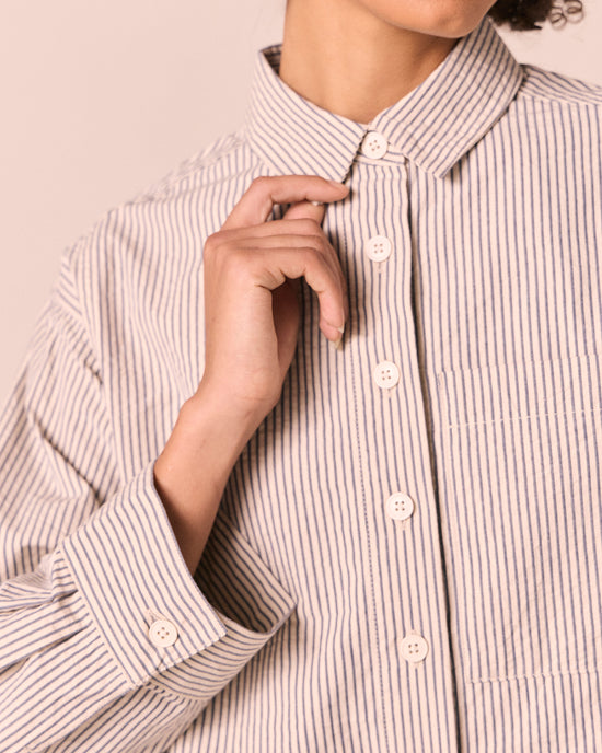 model wears anya blue and bone stripe seersucker shirt