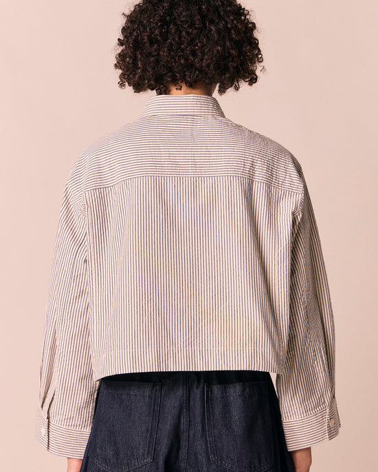model wears anya blue and bone stripe seersucker shirt