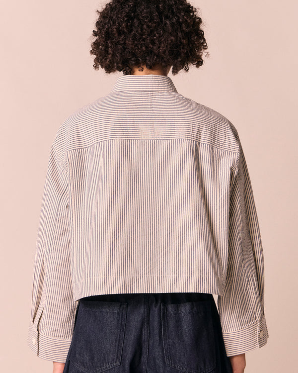 model wears anya blue and bone stripe seersucker shirt