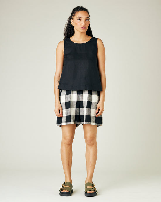 model wears stone and black check ari shorts