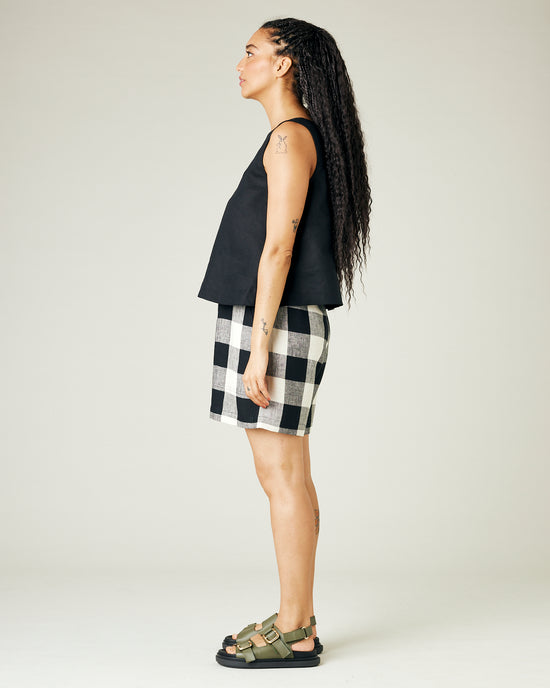 model wears stone and black check ari shorts