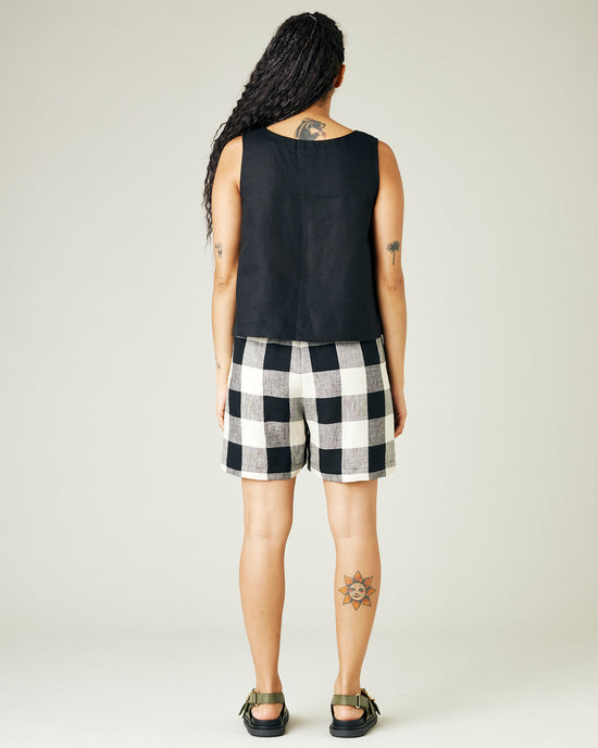 model wears stone and black check ari shorts