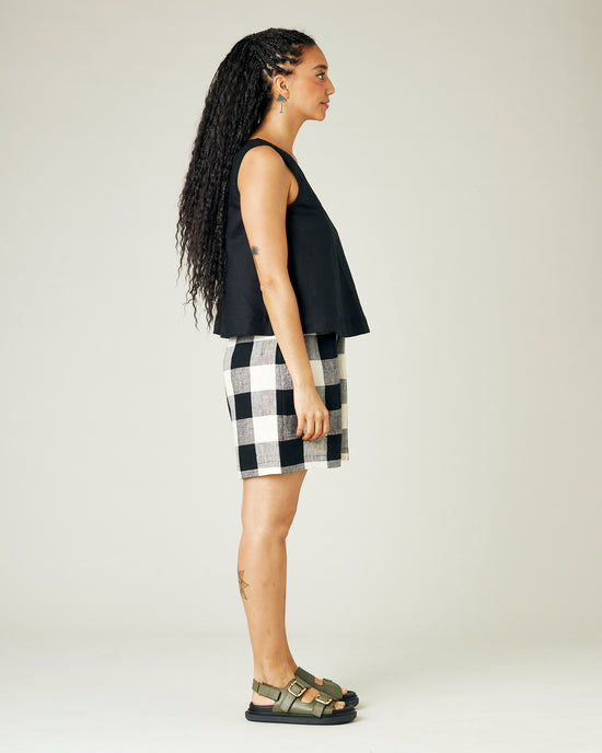 model wears stone and black check ari shorts