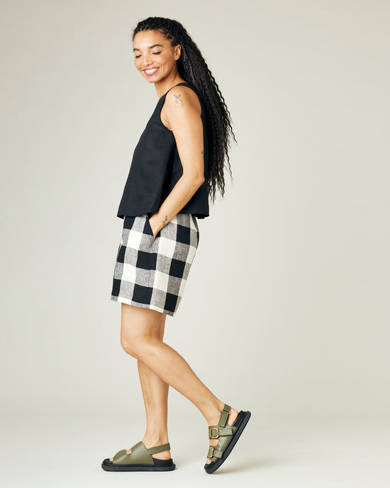 model wears stone and black check ari shorts