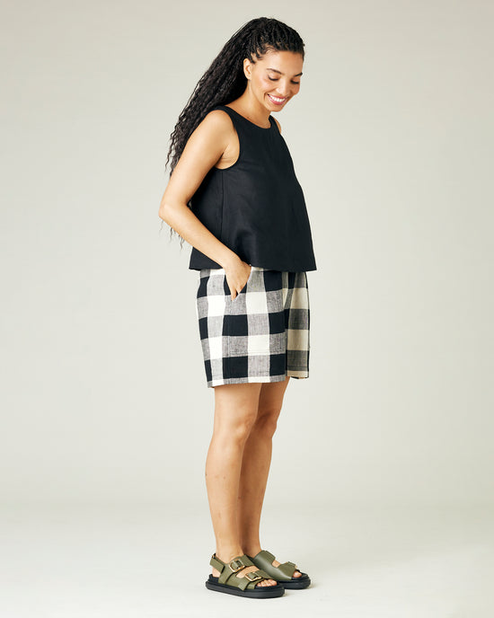 model wears stone and black check ari shorts