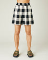 model wears stone and black check ari shorts