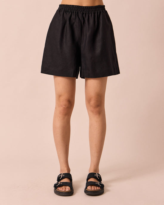 model wears arielle black linen shorts