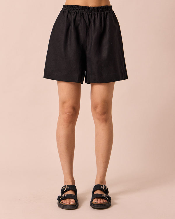 model wears arielle black linen shorts