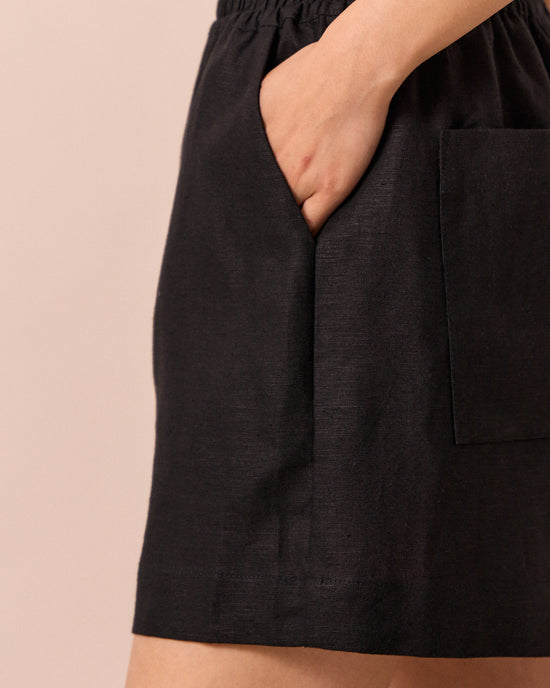 model wears arielle black linen shorts