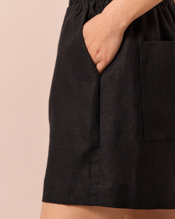 model wears arielle black linen shorts