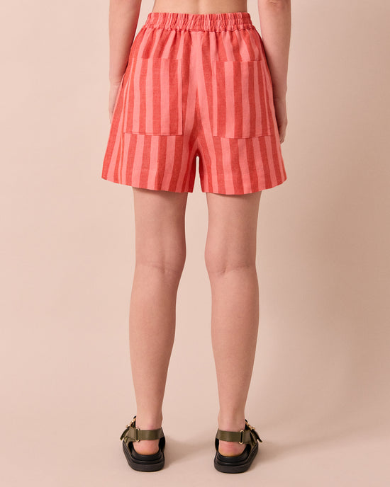 model wears arielle sorbet stripe linen shorts