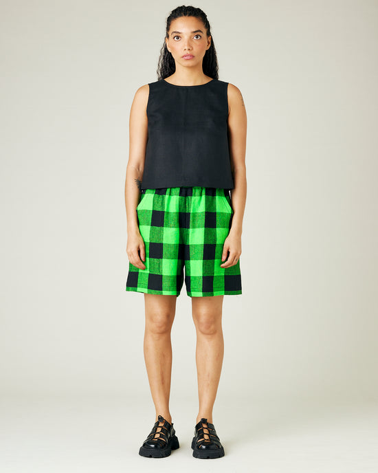 model wears green and black check ari shorts