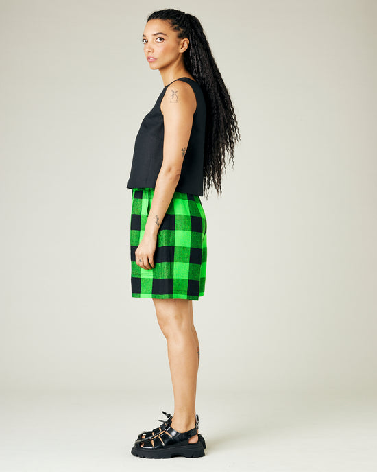 model wears green and black check ari shorts