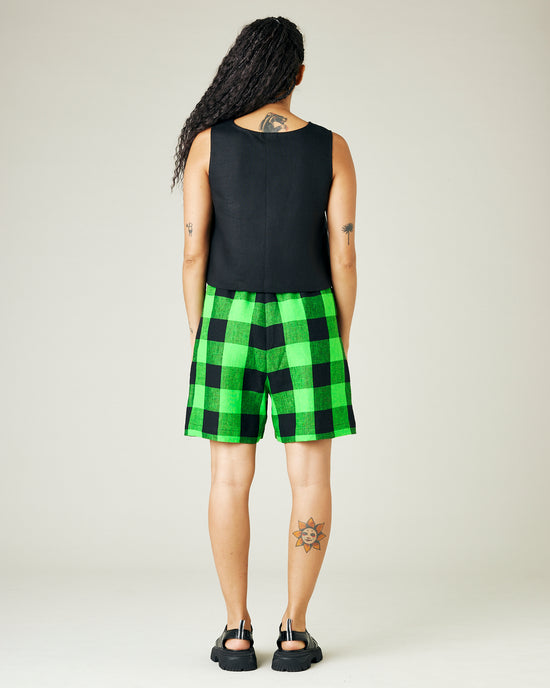 model wears green and black check ari shorts