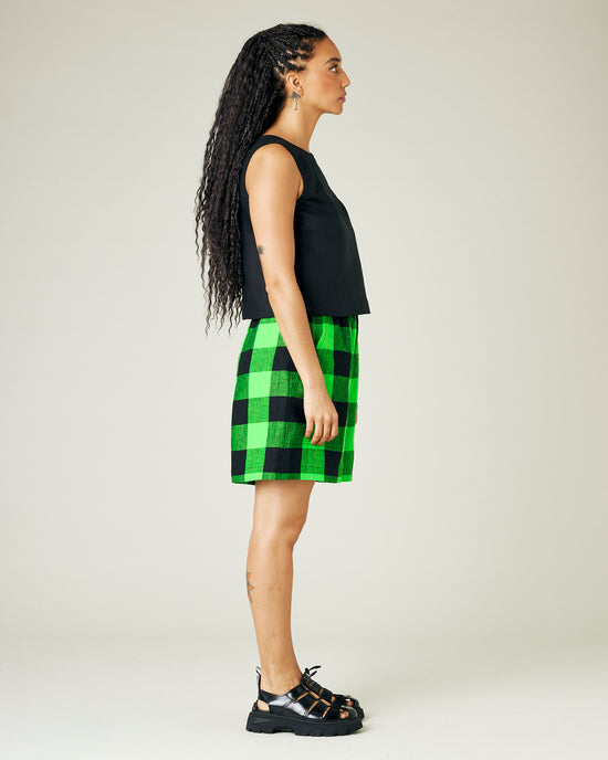 model wears green and black check ari shorts