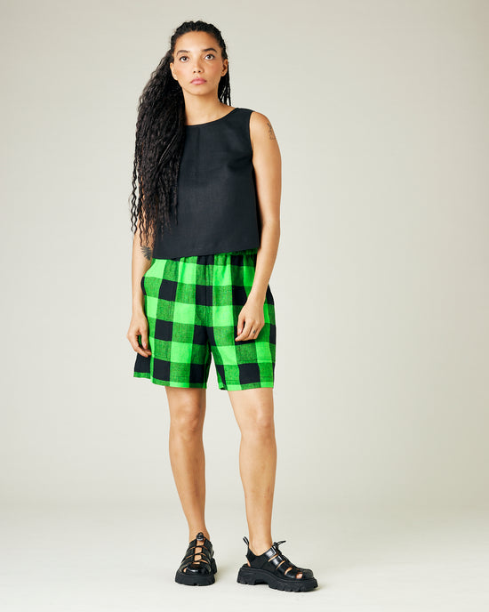 model wears green and black check ari shorts