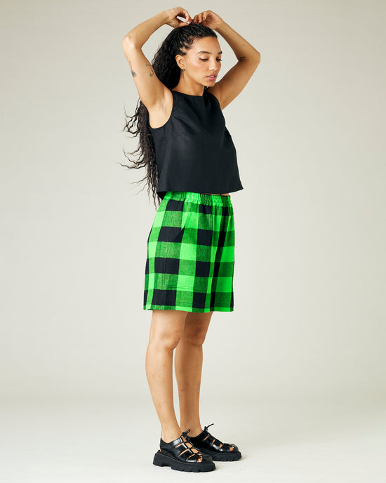 model wears green and black check ari shorts