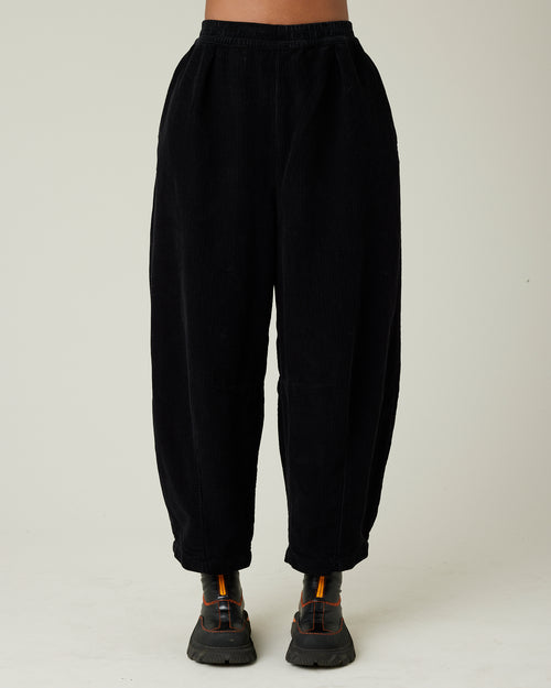 model wears daisy black cord trousers front