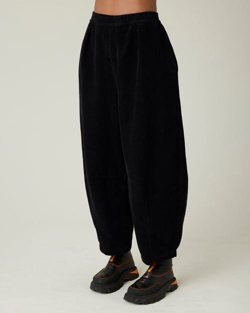 model wears daisy black cord trousers left