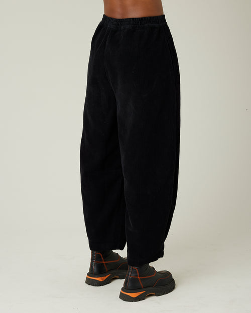 model wears daisy black cord trousers right