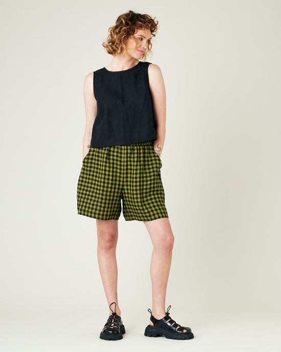 model wears green gingham ari shorts