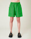 model wears green and black check ari shorts